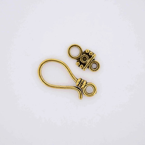 Gold jewelry finding hook clasp.
