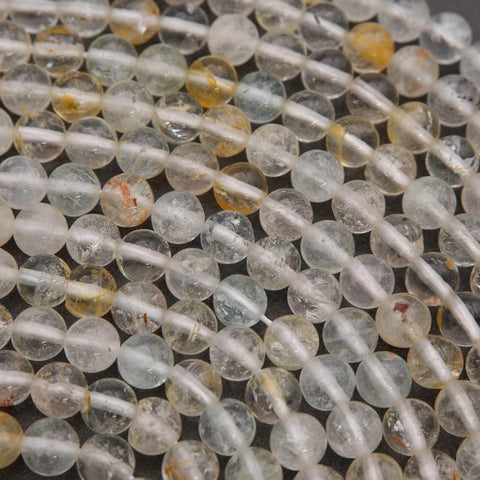 Clear topaz beads with yellow inclusions.