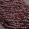 Close-up of faceted red beads on a gray background