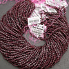 Burgundy braided hair extensions with product tags on a gray background
