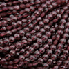Close-up of dark red beads on a dark background