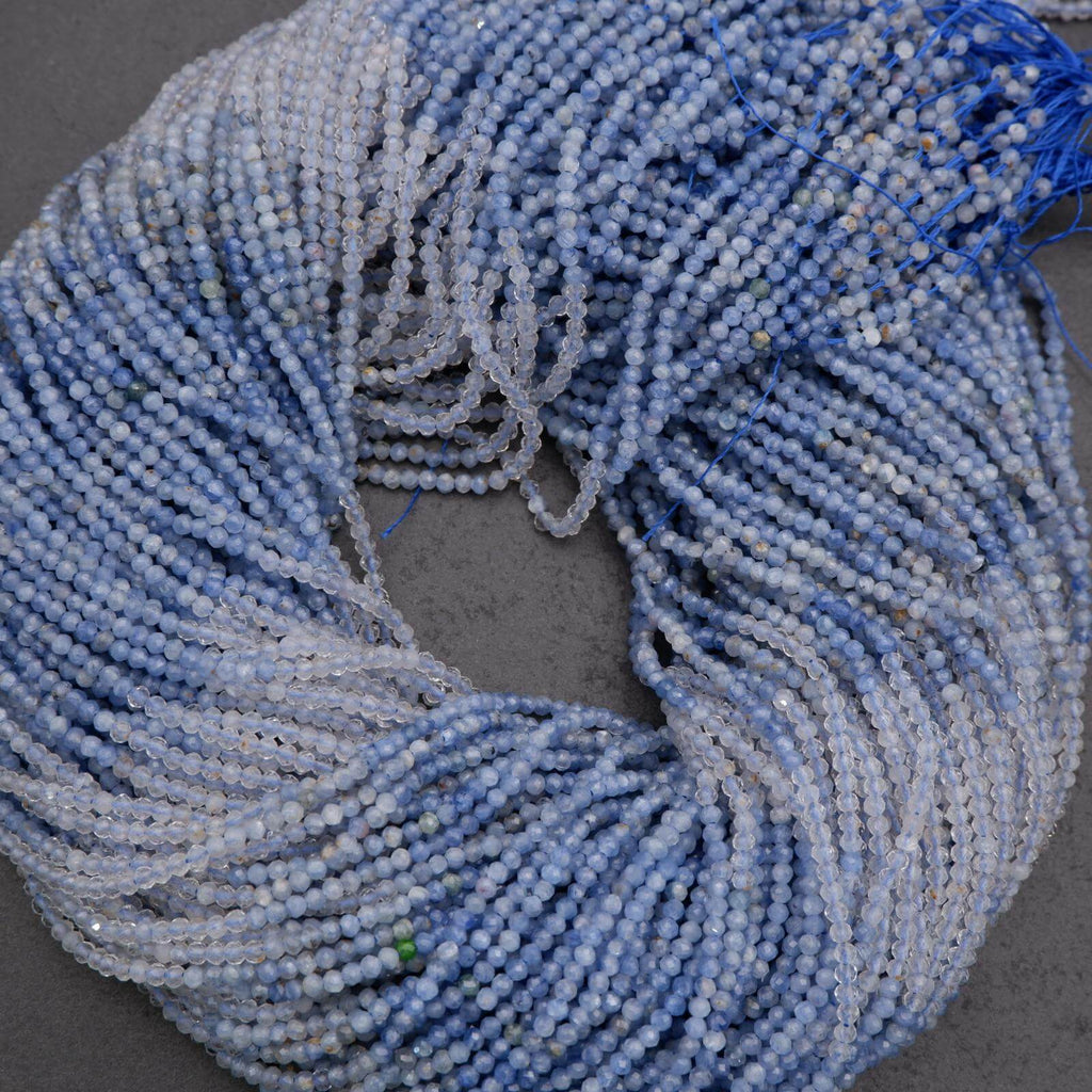 Close-up of blue beaded strands on a dark surface