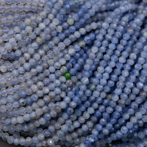 Close-up of blue beads with a green bead amidst them