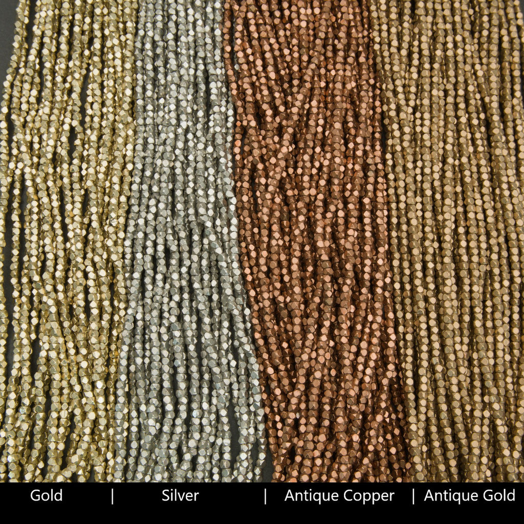 Close-up of gold, silver, antique copper, and antique gold beaded strands.