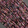 High-density corundum beads in ruby and sapphire tones with soft reflective polish