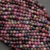 Gemstone beads made of ruby and sapphire, showcasing natural matrix and inclusions