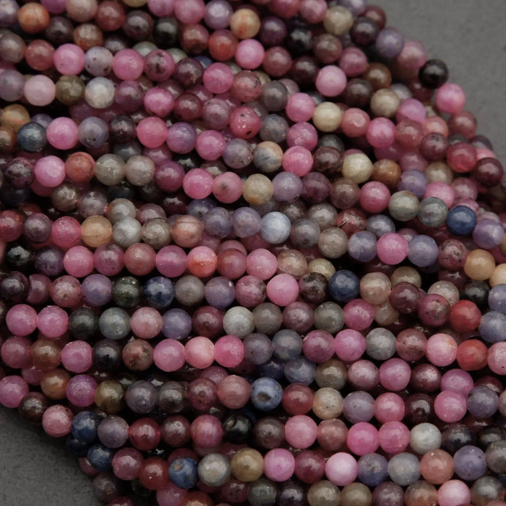 Gemstone beads made of ruby and sapphire, showcasing natural matrix and inclusions