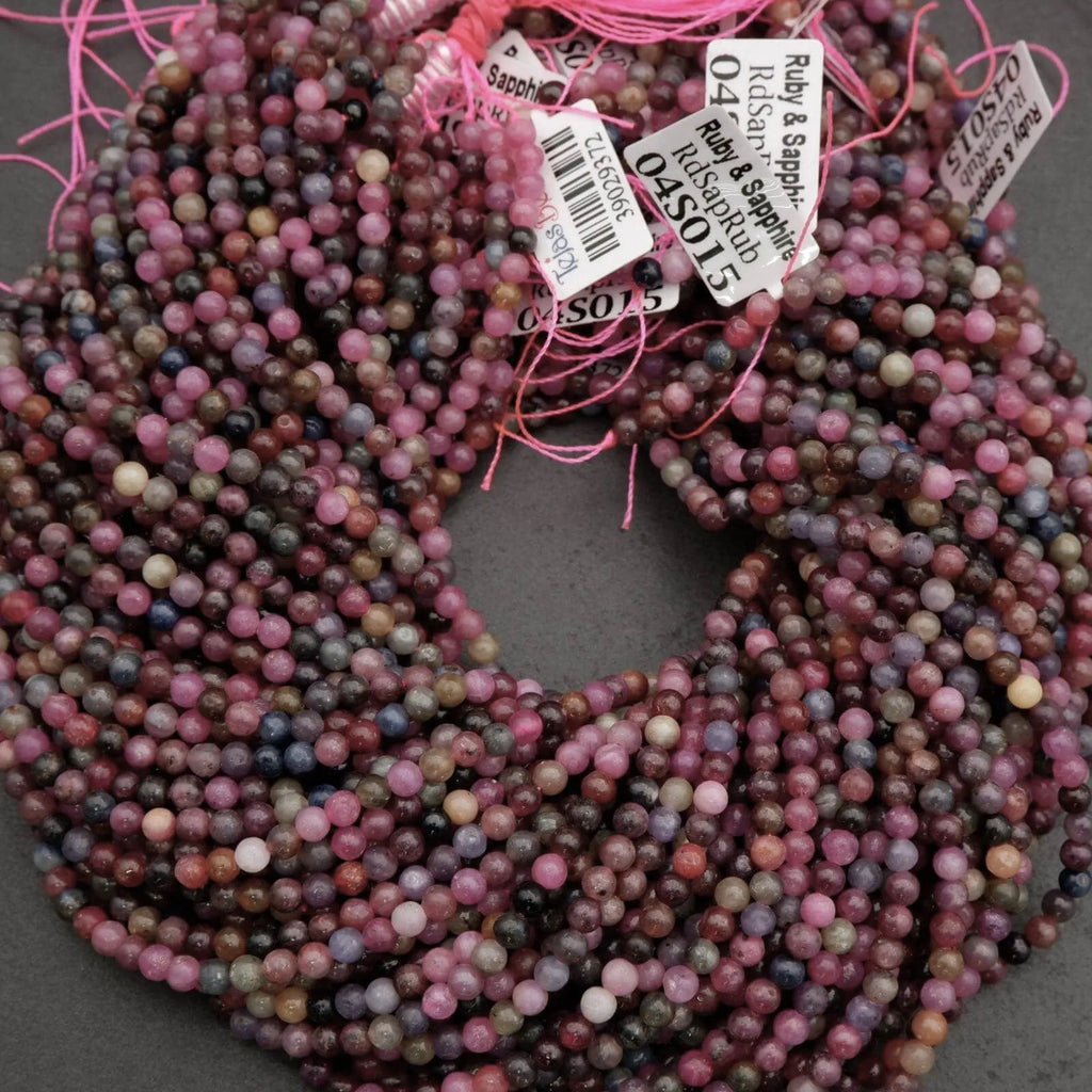 Multicolored bead strands with pink string on a gray background