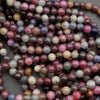 Close-up of natural ruby and sapphire gemstone beads in mixed deep and pastel hues