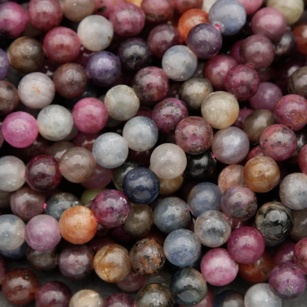 Mixed ruby and sapphire gemstone strands with rich colors and reflective surface