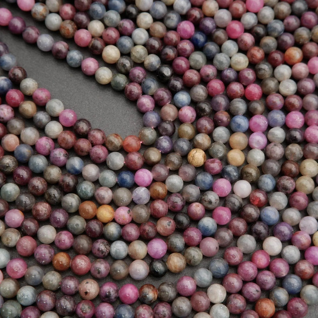 Ruby and sapphire gemstone beads with glossy finish and earthy, organic tones