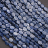 Close-up of blue oval beads on a dark background