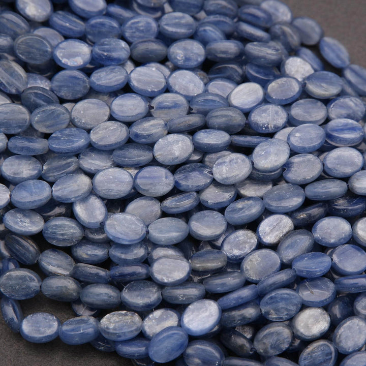 Close-up of blue oval beads on a dark background