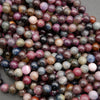 Multicolor corundum beads featuring ruby and sapphire hues with natural inclusions