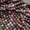 8mm round ruby and sapphire beads showing deep jewel tones and silky matrix patterns
