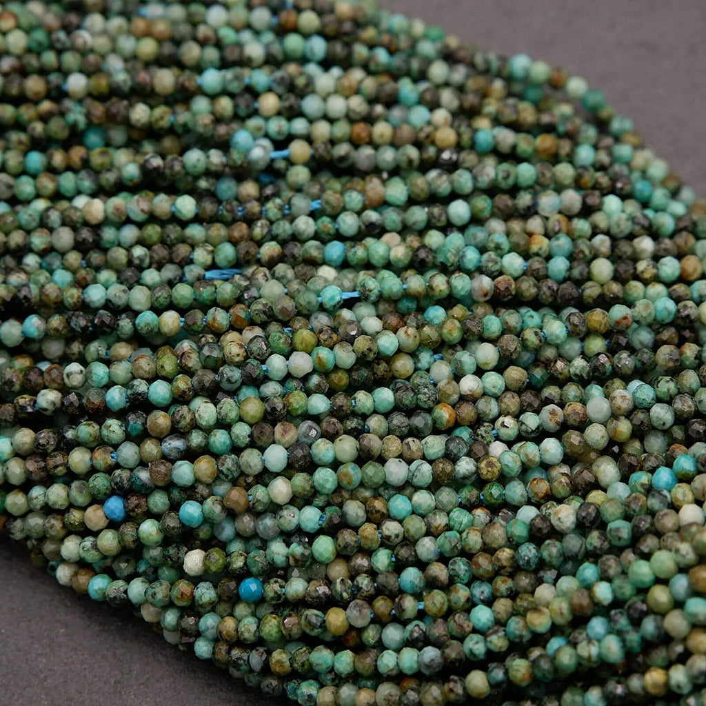 Close-up of a string of green and brown beads on a gray background