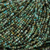 Close-up of green and brown beads on a string