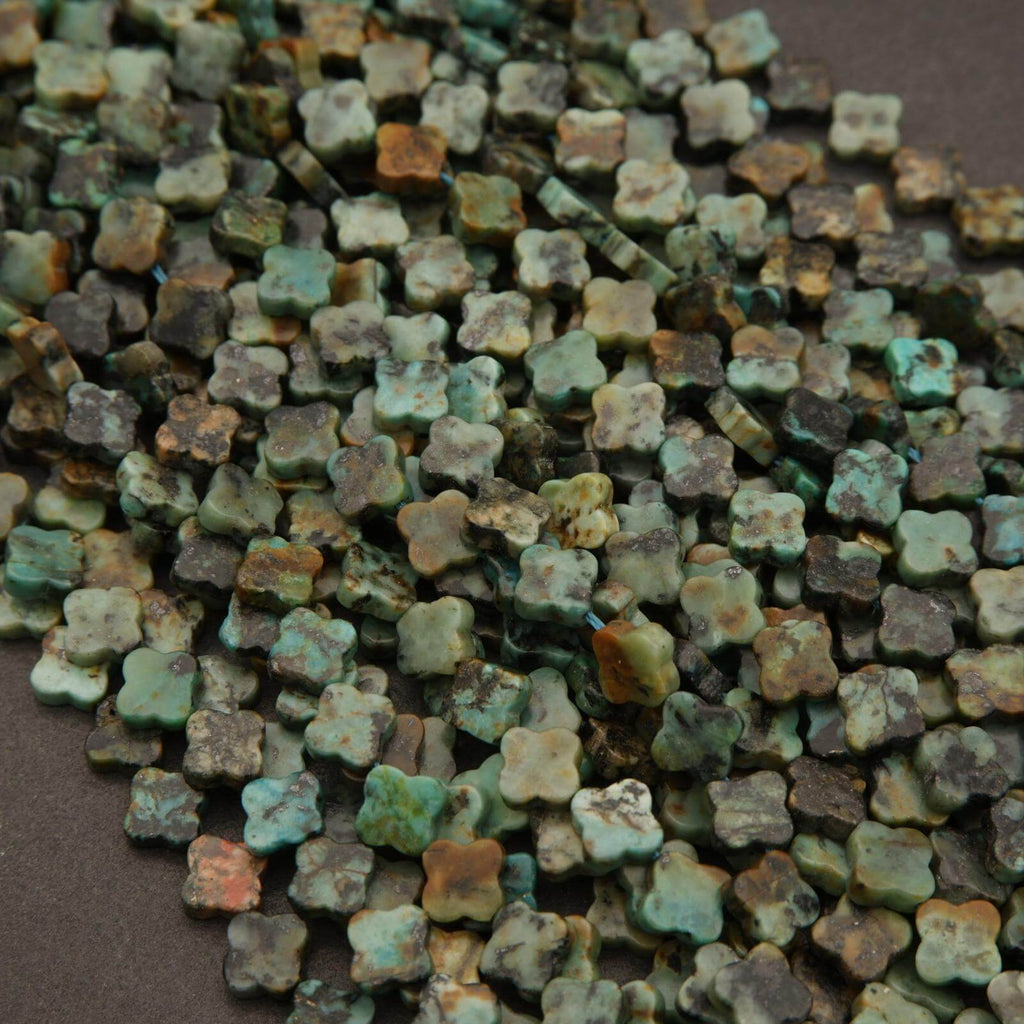 Close-up of small, multicolored ceramic tiles on a brown background