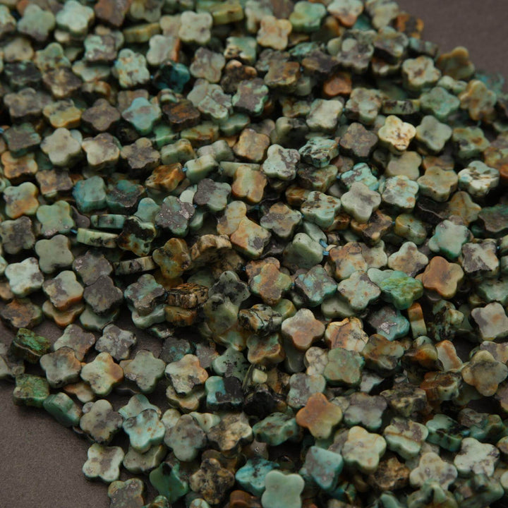 Close-up of small, multicolored ceramic tiles with a brown background