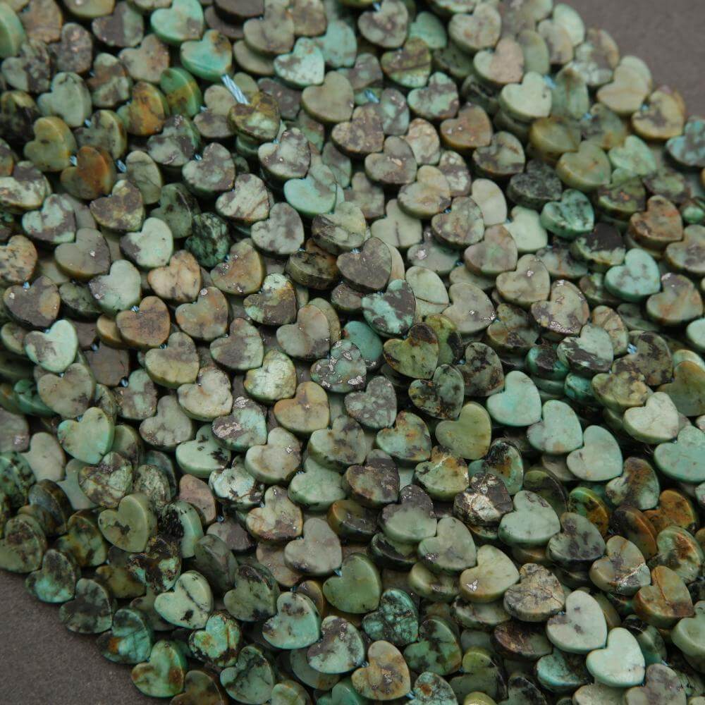 Small heart-shaped stones in various shades of green and brown.