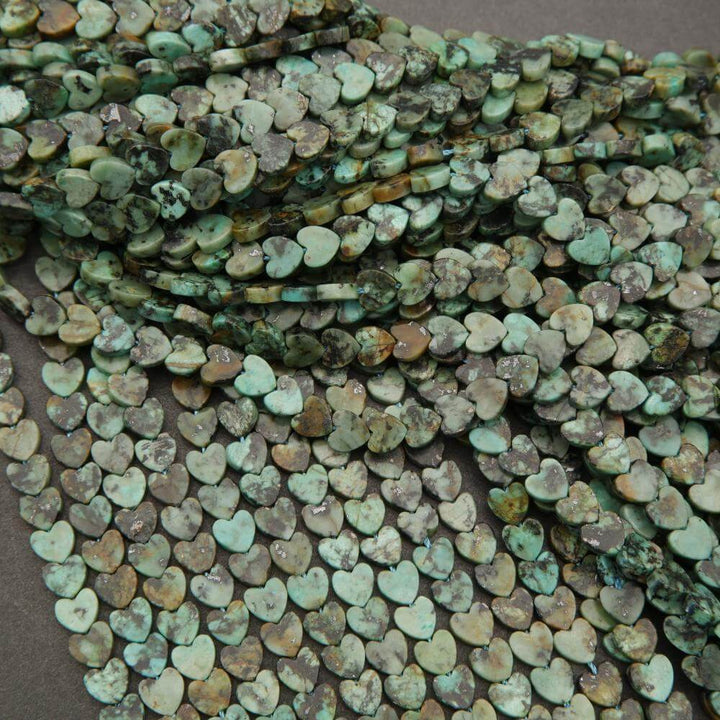 Turquoise heart-shaped beads on a dark surface