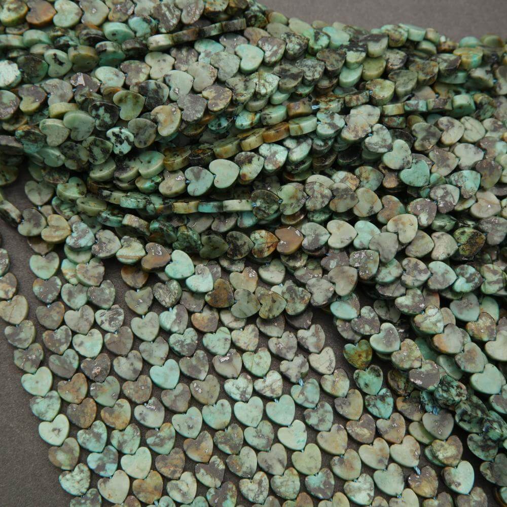 Turquoise heart-shaped beads on a dark surface