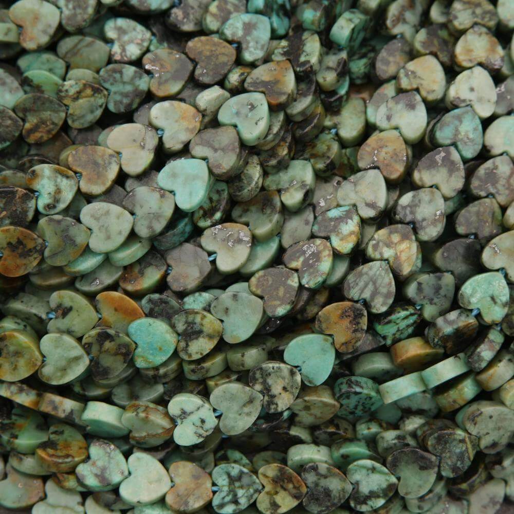 Close-up of heart-shaped turquoise stones with various shades.