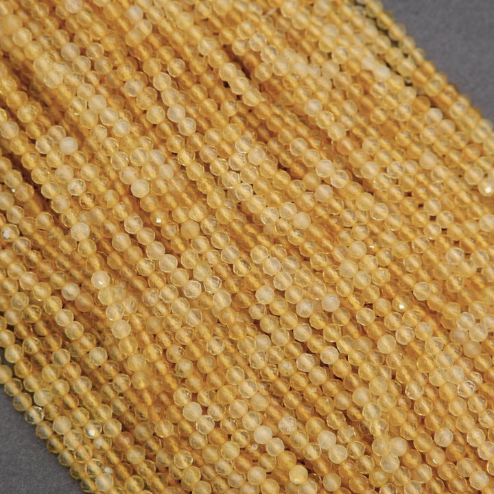 Close-up of a string of yellow beads on a gray background