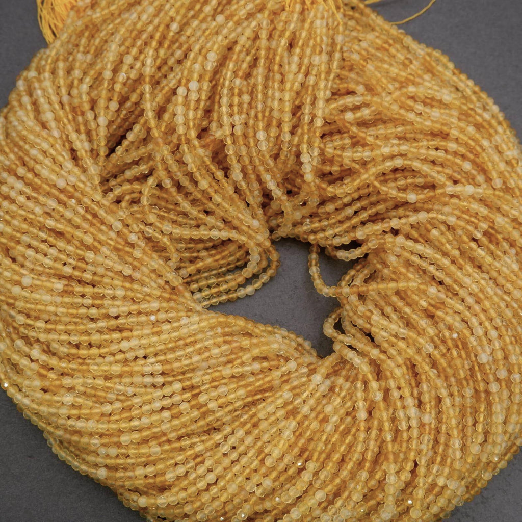 Close-up of a skein of gold yarn on a gray background