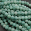 Close-up of teal beads on a dark background