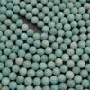 Close-up of teal beads on a black background