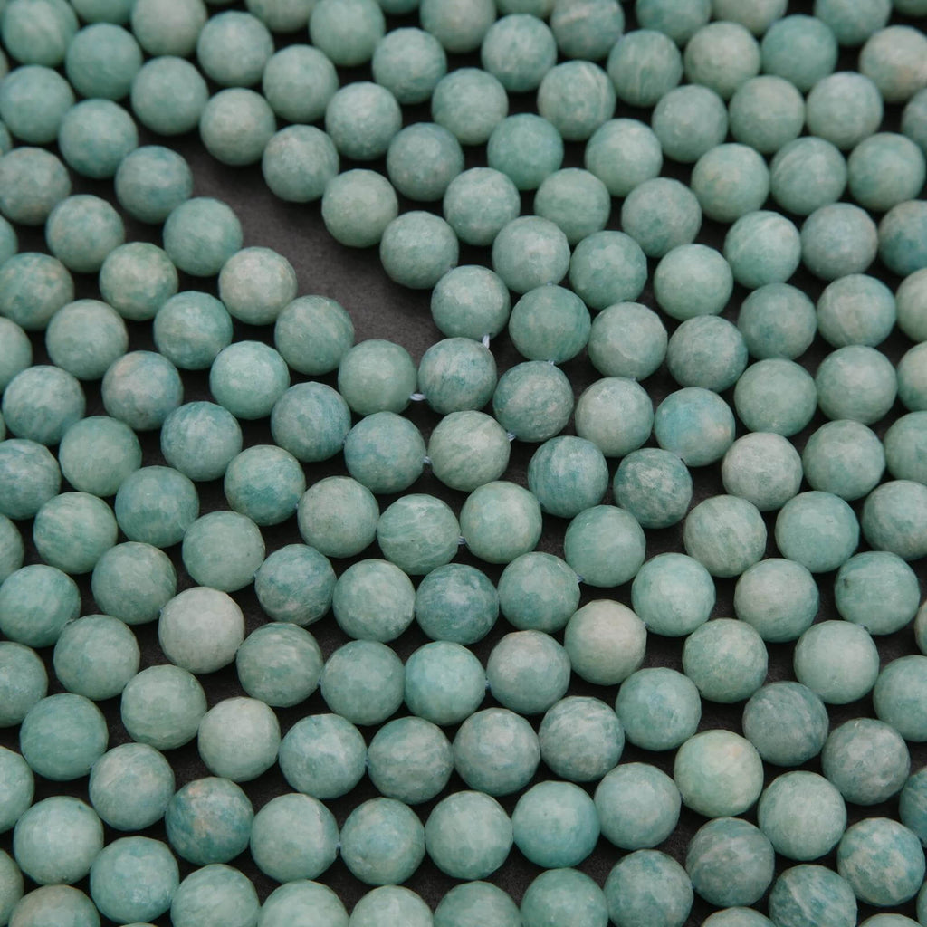 Close-up of teal beads on a black background