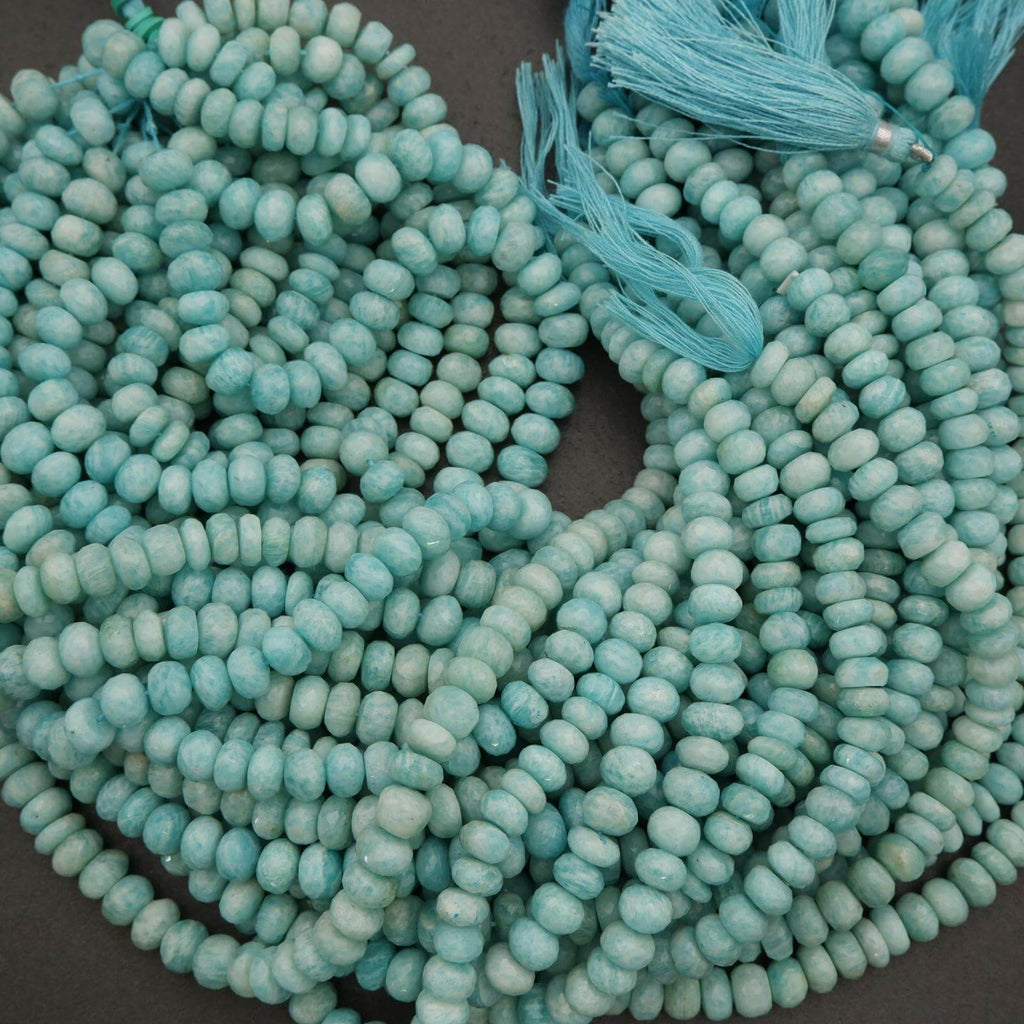 Turquoise glass beads with tassels on a dark background