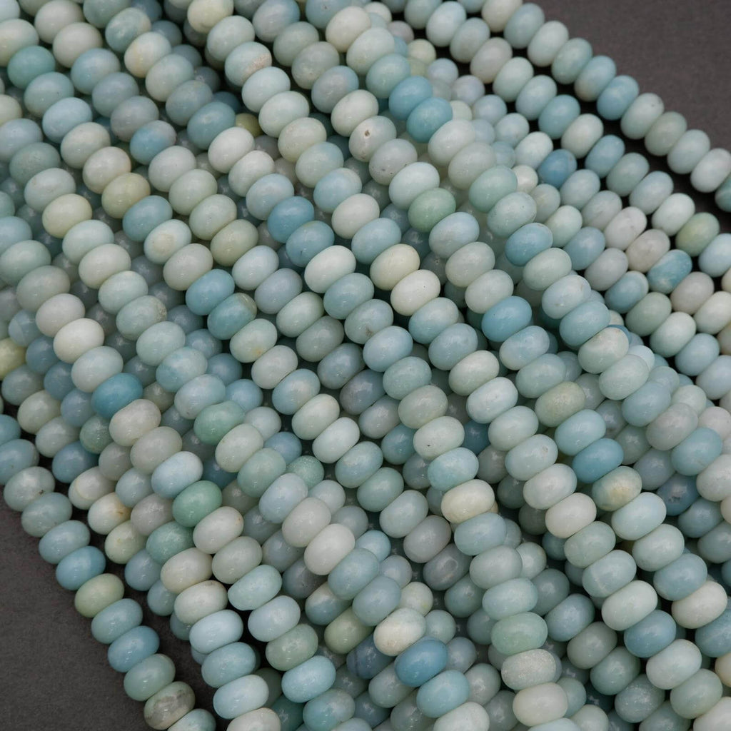 Close-up of light blue and green beads on a dark background