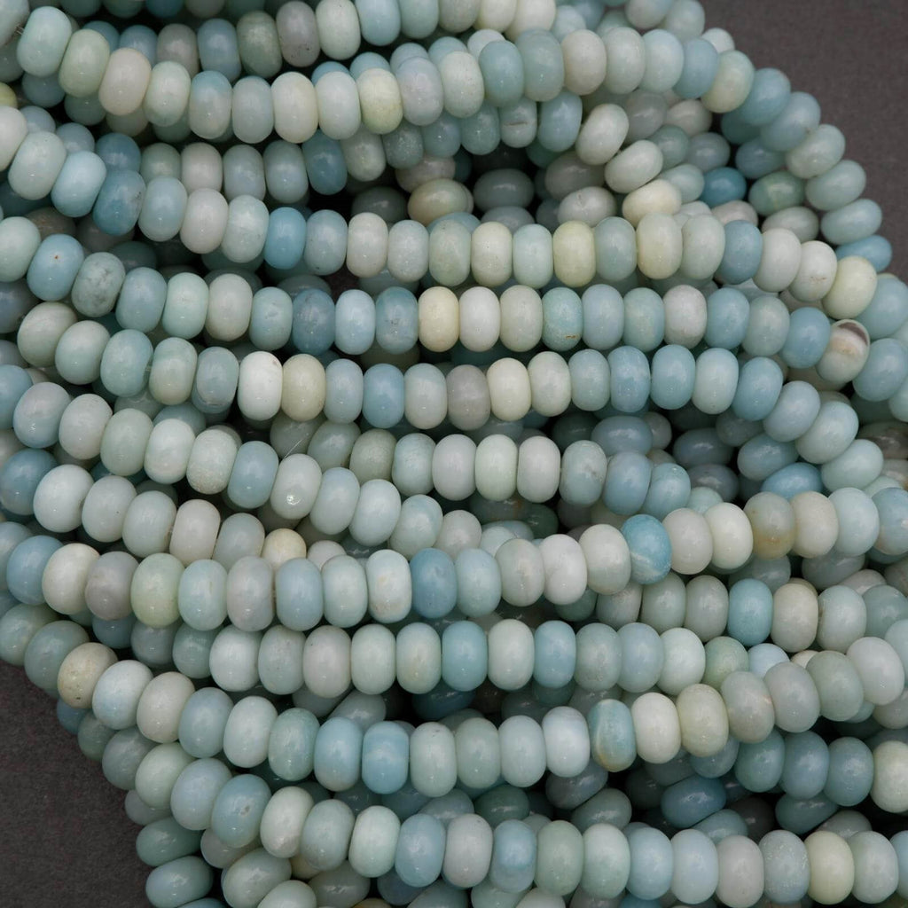 Close-up of light blue and white beads on a dark background