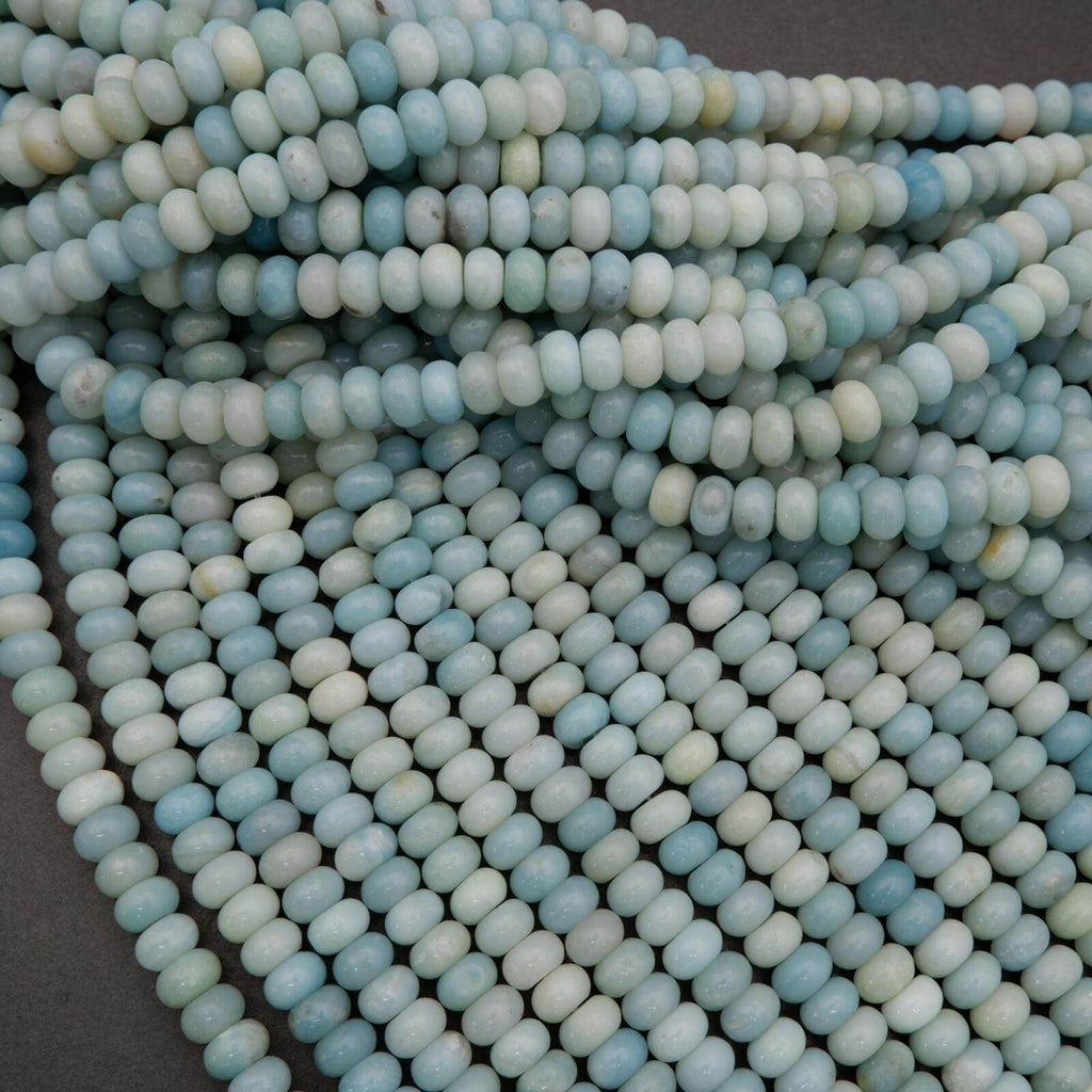 Close-up of light blue beads on a dark background