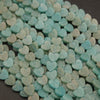 Turquoise heart-shaped candies on a dark surface