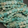 Turquoise heart-shaped stones on a dark background