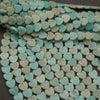 Close-up of turquoise heart-shaped beads on a dark background