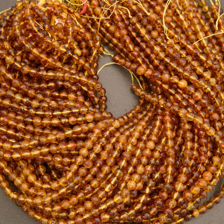 Close-up of amber-colored beads on a gray background