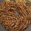 Coiled string of multicolored beads on a gray background