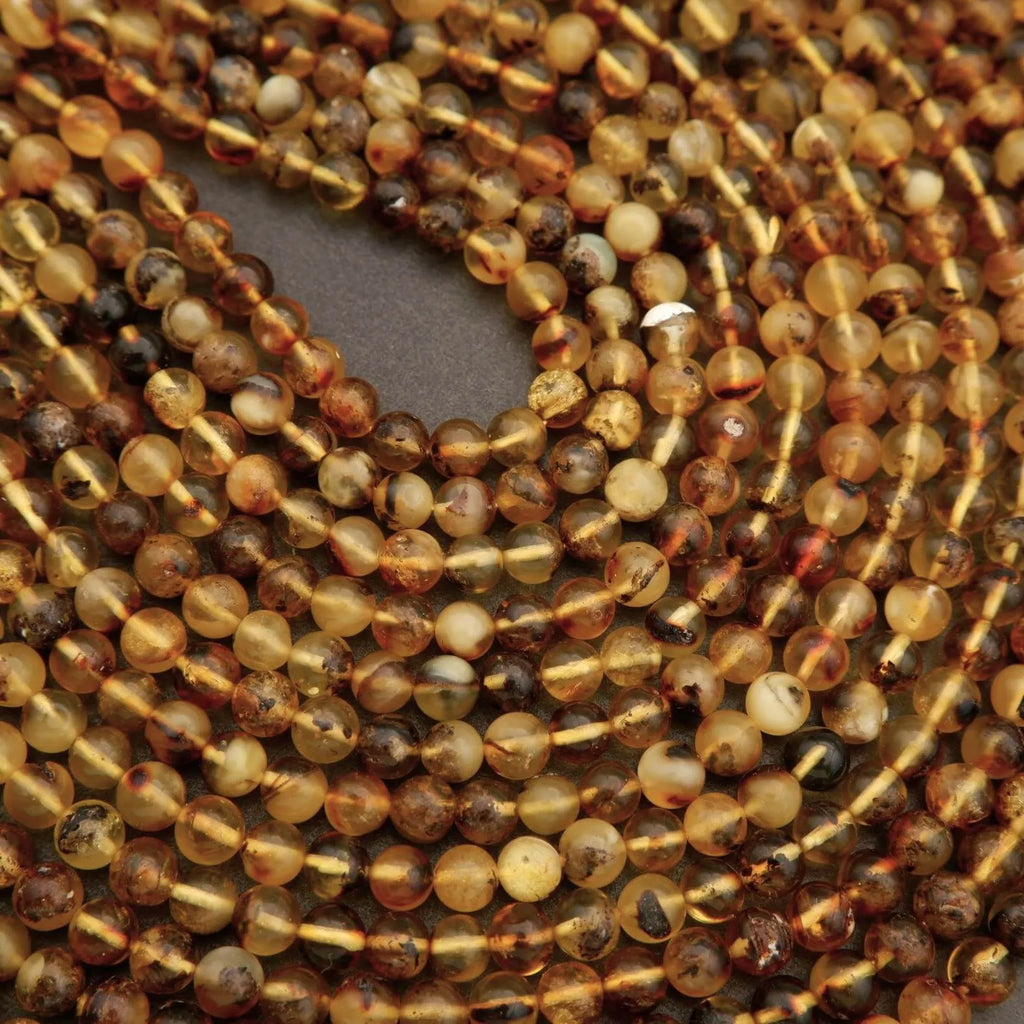 Close-up of multicolored bead strands on a dark background