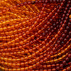 Close-up of amber-colored beads in a spiral pattern