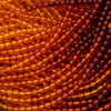 Close-up of amber-colored beads in a spiral pattern