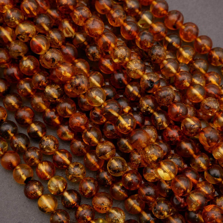 Close-up of amber beads showing natural translucence and internal inclusions.