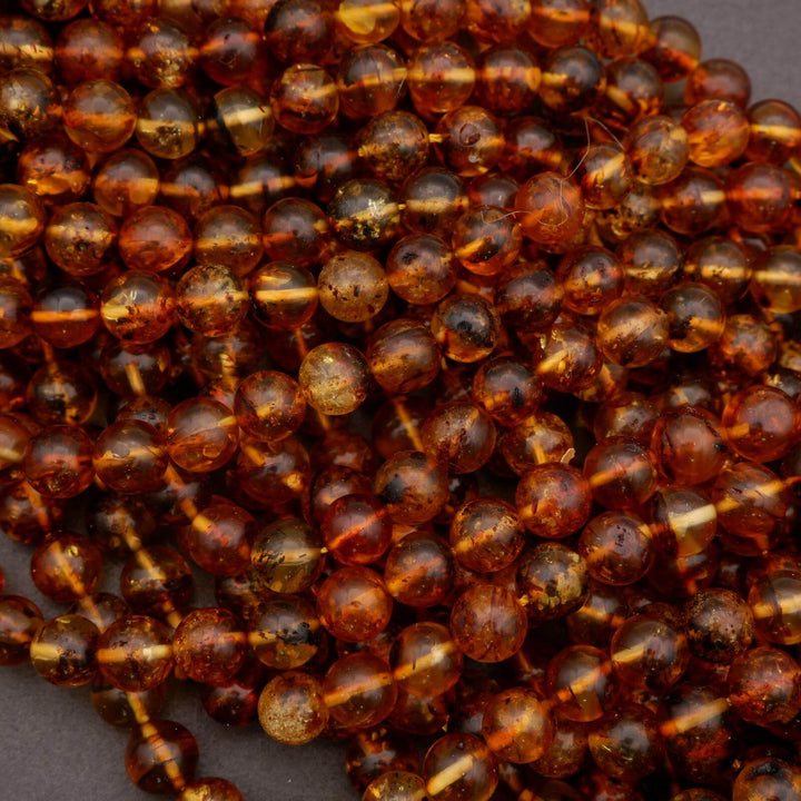 Strands of amber beads with rich golden-brown color variation.