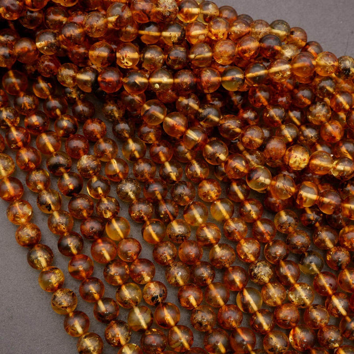 Natural amber beads with smooth round shape and warm glow.