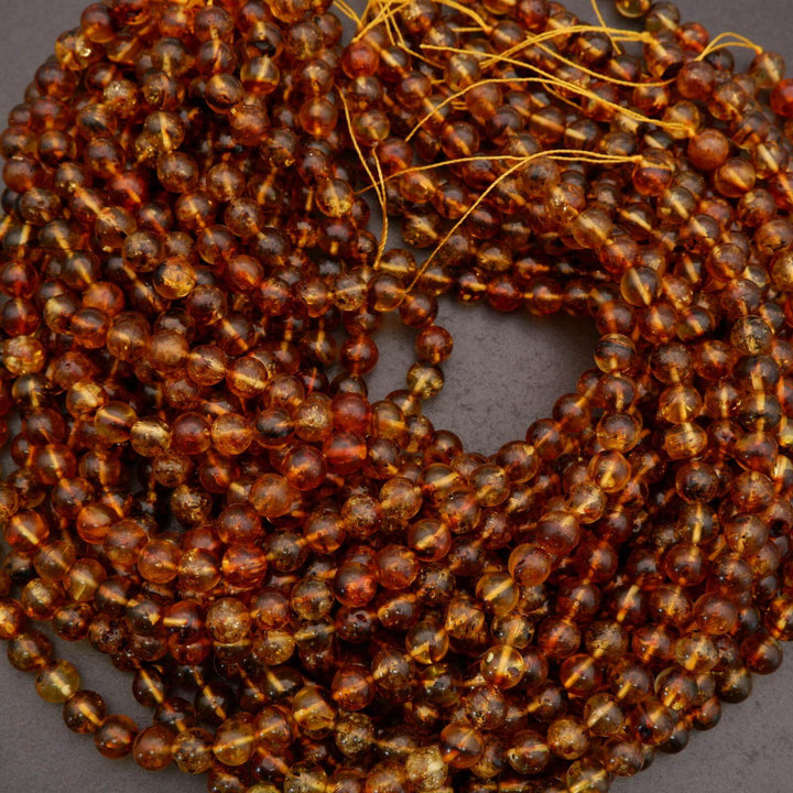 Detail view of amber gemstone beads with organic texture and depth.