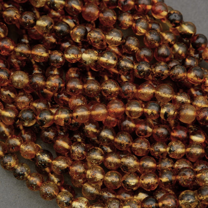 Close-up of a string of brown beads on a gray background
