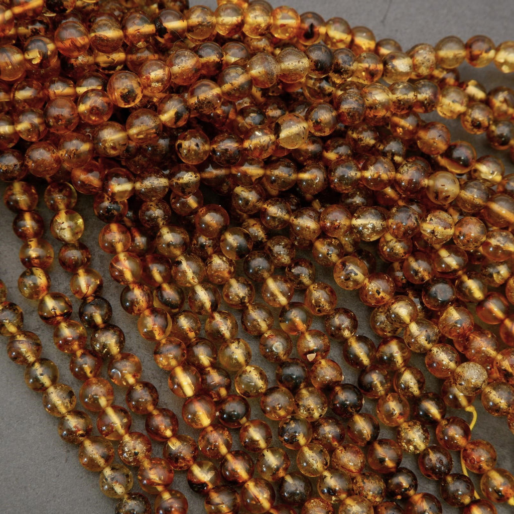 Close-up of amber-colored beads on a gray background